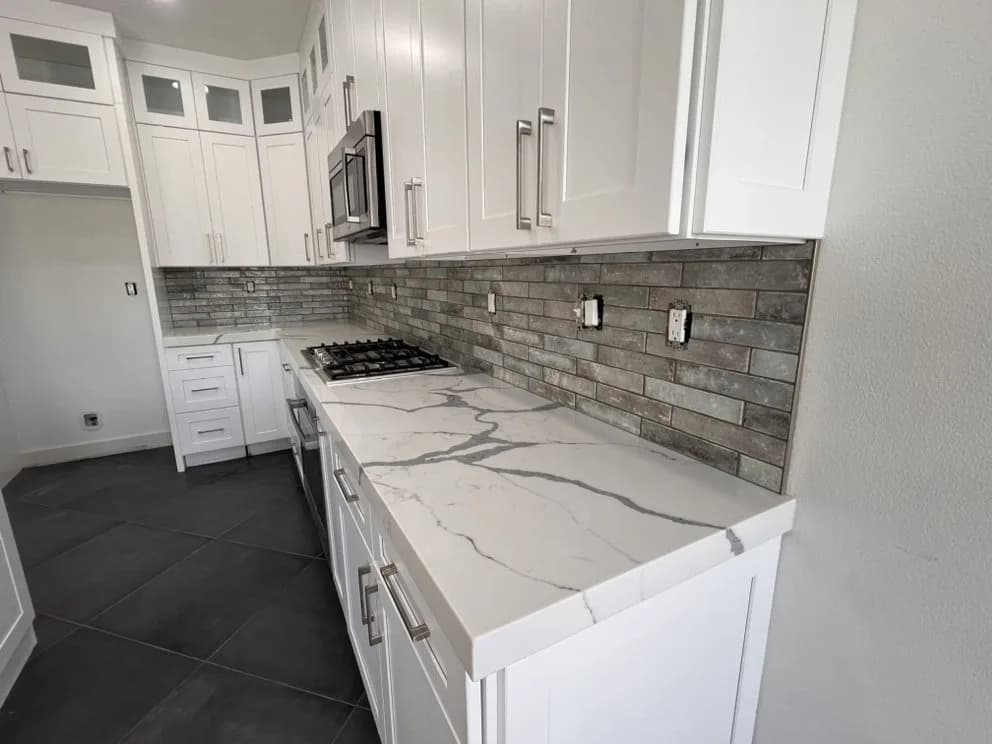 Detailed view of Laguna Niguel kitchen countertop fabrication and backsplash work